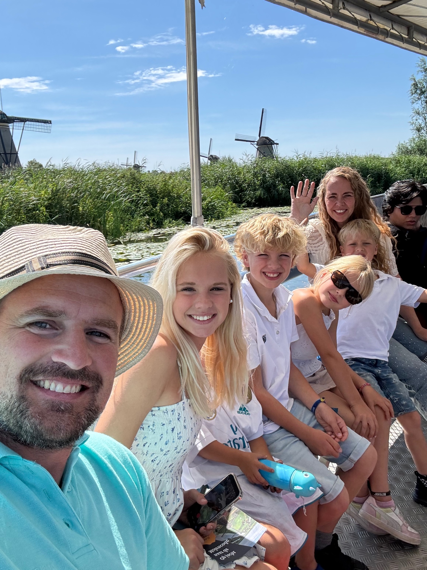 The Heroes Family on a boat at Kinderdijk, with windmills in the background